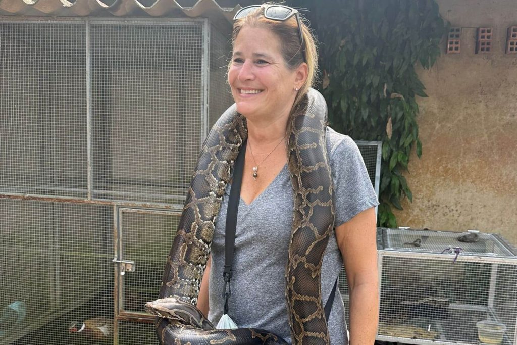 woman photo with snake - saigon local tour