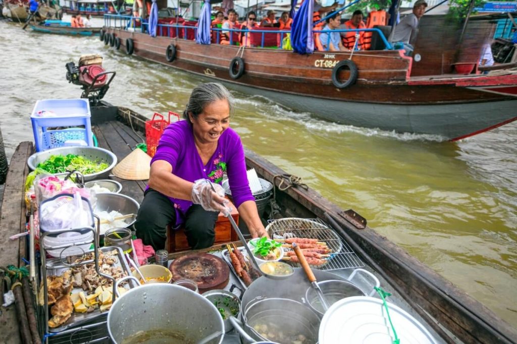 Enjoy Vietnam traditional food in Cai Rang Floating Market - mekong delta tour package from ho chi minh city
