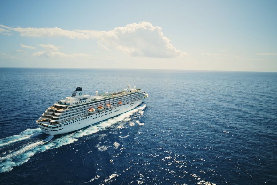 Large cruise ship sailing through calm waters in Southeast Asia